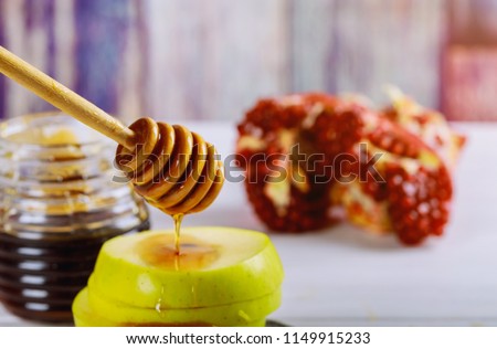 rosh hashanah jewesh holiday concept shofar, torah book, honey, apple and pomegranate. traditional holiday symbols.