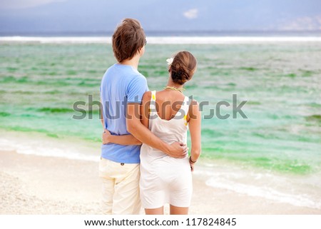 attractive  young couple looking on the horizon. honeymoom