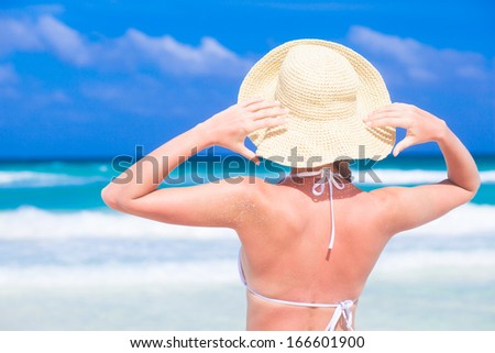 young happy woman in white bikini enjoys sunny day on beach. Tulum, Mexico
