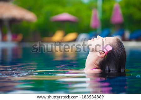 half face portrait of beautiful woman in luxury pool