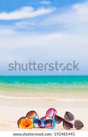 many sunglasses lying on tropical lying beach