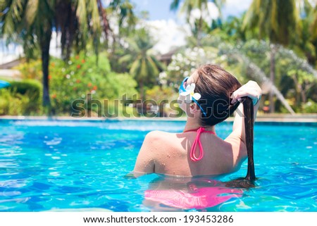 back view of long haired woman in pool