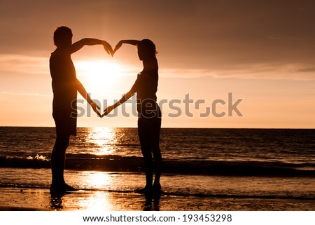 silhouette of two people in love at sunset