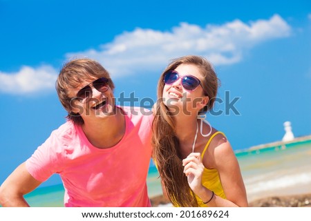 happy young couple enjoying their time at tropical beach