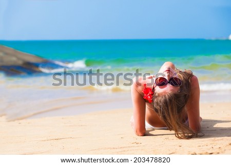 long haired woman in bikini on tropical beach