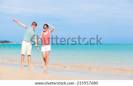 happy young couple enjoying their time at tropical Thailand beach