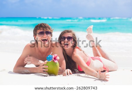 close up of young couple enjoying their time drinking a coconut cocktail