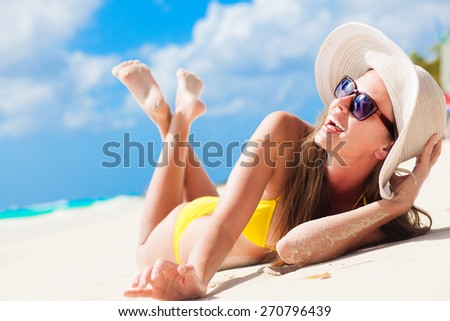 long haired girl in bikini having fun on tropical barbados beach