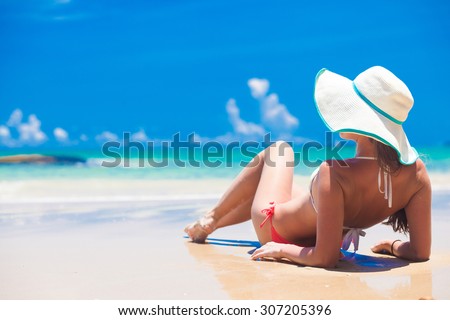 Fit woman in sun hat and bikini at beach.remote tropical beaches and countries. travel concept