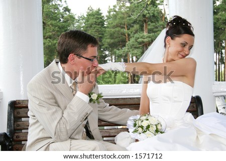 Married. Bridegroom kisses hand of bride. Focus on groom and hand.