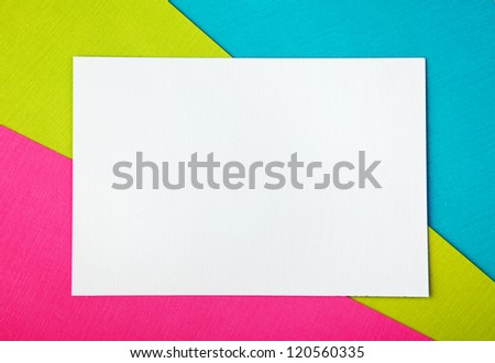 three sheets of colored paper with a clean sheet of white paper