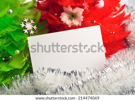 green and red christmas tree made of feathers with greeting cards