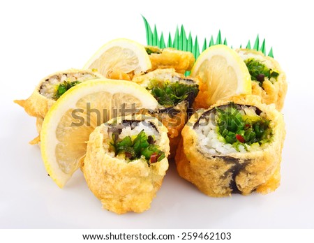 sushi roll fried in tempura batter with lemon isolated