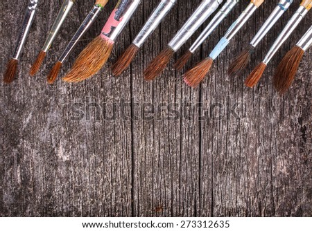 brushes for painting  on vintage wooden  background