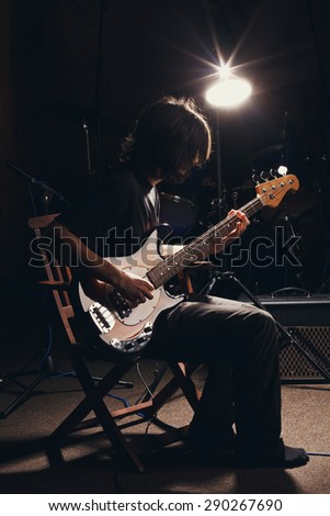 hairy guy playing bass guitar