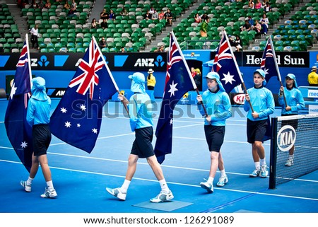 MELBOURNE - JANUARY 26: Ballkids with Australian flags at a trophy presentation at the 2013 Australian Open on January 26, 2013 in Melbourne, Australia.
