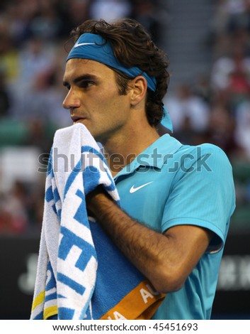 MELBOURNE - JANUARY 27: Roger Federer wipes his face at his win over Nikolay Davydenko during a quarter final match in the 2010 Australian Open on January 27, 2010 in Melbourne