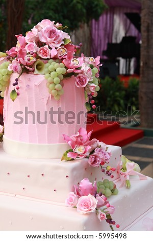 stock photo Pink Wedding cake decorated with flowers and grapes