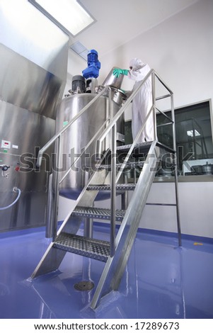 an operator working in manufacturing facility in pharmaceutical factory