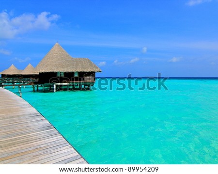Paradise water villas over azure sea in Maldives