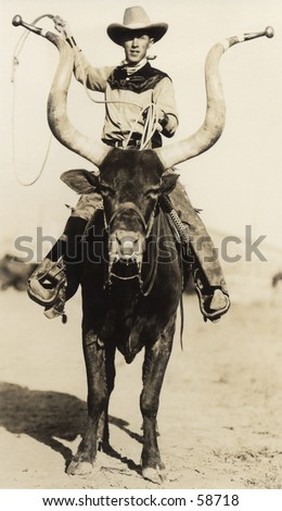 Vintage photo, circa 1900, of a cowboy riding a longhorn steer