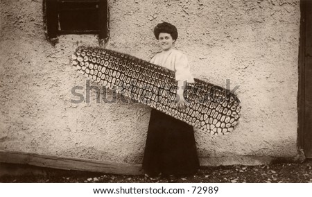 Vintage hoax photo of woman with huge ear of corn