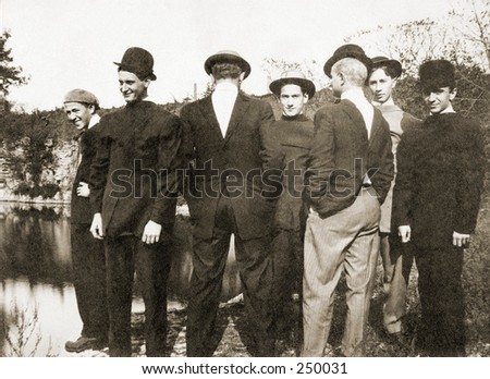 Vintage Photo of a Group of Young Men With Coats On Backwards