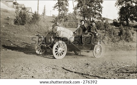 Vintage Photo of a Man And Woman Driving Old Car