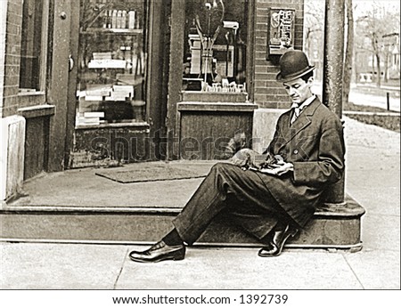 Vintage photo of a Man In Suit And Hat Sitting On Curb Feeding Squirrel