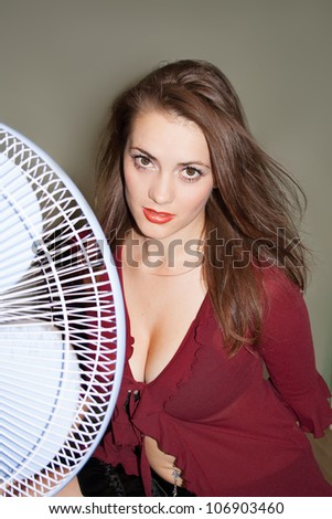 The fan blows to face of woman