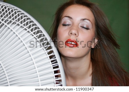 The fan blows to face of woman