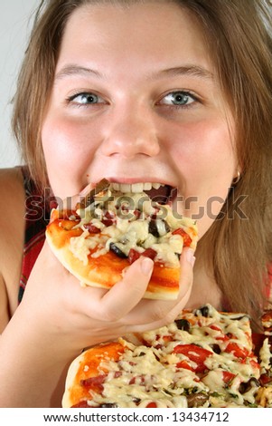 Beautiful no make-up girl eating a piece of Pizza