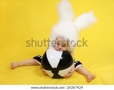 little girl in a white downy bunny costume.