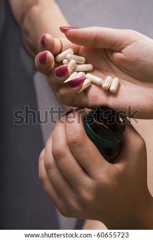 Healthcare and medicine: Young woman has control over pills.