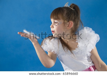 The girl the princess in a white dress opposite to a blue background