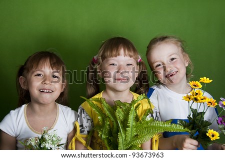 Three girls of the girlfriend - the cheerful company. Green background