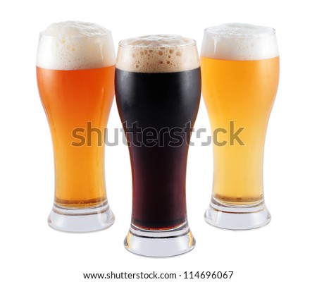 three glasses with different types of blond beer toast and isolated black and with clipping path