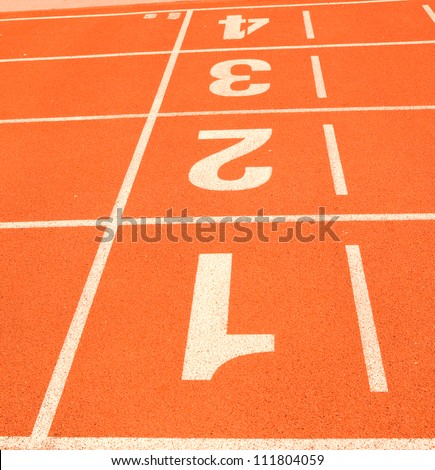 White finish line on the orange track and field tartan