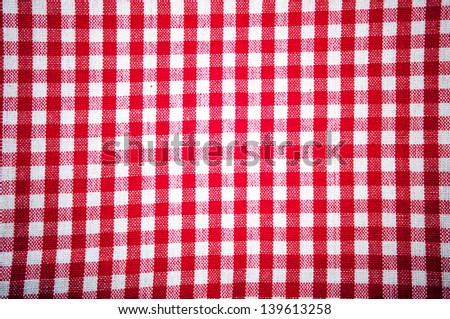Red and white grid with a kitchen cloth as background