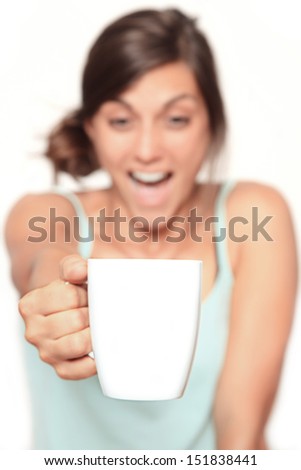 happy coffee junkie - blurry face with focus on the big white cup with copy space - isolated on white