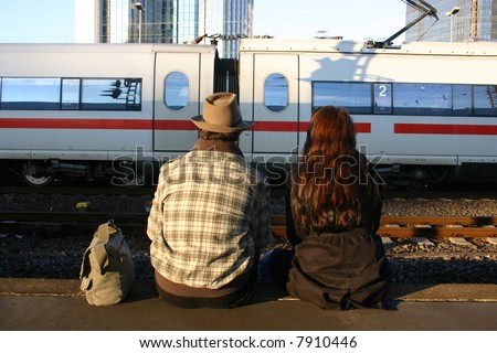 couple at the station waiting for the delayed train