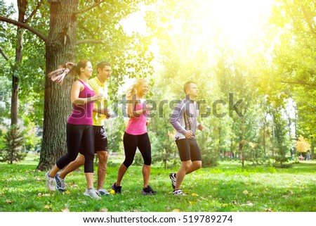 Group of people running in the park on a morning sunshine