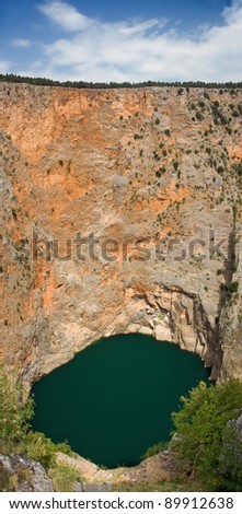 Red lake is a limestone crater, with it\'s cliffs 200 m high and lake 300 m deep