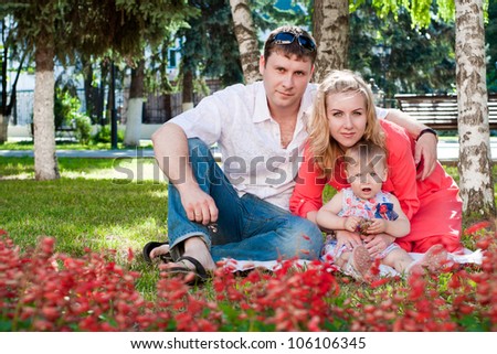 young family on walk in a summer garden