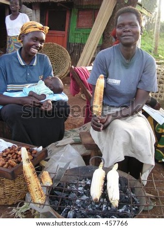 Kenyan market ladies roast corn cobs on charcoal brazier