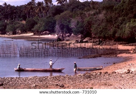 Fisherman use dugout canoes to check their nets on east Africa\'s coast.