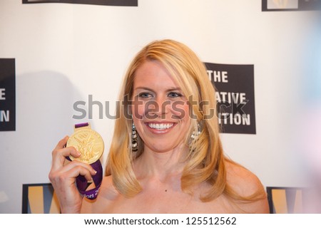 WASHINGTON - JANUARY 21:  Olympic rower Esther Lofgren holds her gold medal as she arrives at the Creative Coalition inaugural ball on January 21, 2013 in Washington, DC.
