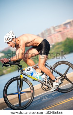 WASHINGTON - September 8: An athlete cycles in The Nation\'s Triathlon on September 8, 2013 in Washington, DC