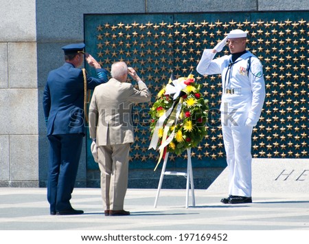 WASHINGTON JUNE 6: A young sailor salutes a World War II veteran during the ceremony marking the 70th anniversary of DDay at the WWII Memorial June 6, 2014 in Washington, DC