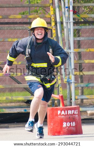 FAIRFAX, VA - JULY 3: A firefighter heads for the finish line in the Ultimate Firefighter competition at the World Police & Fire Games on July 3, 2015